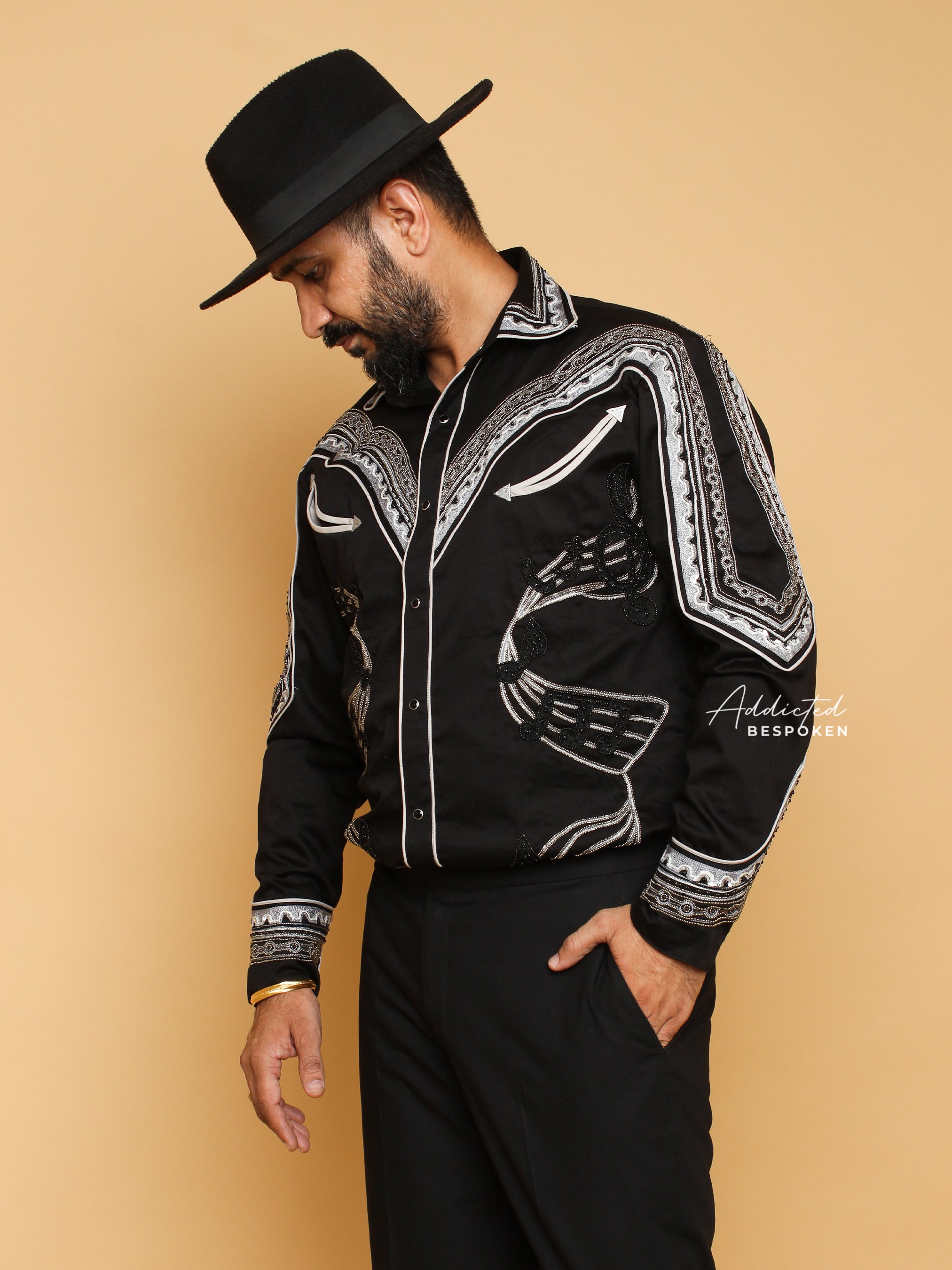 Angled side view of male model in black western shirt with white embroidery – Addicted Bespoken
