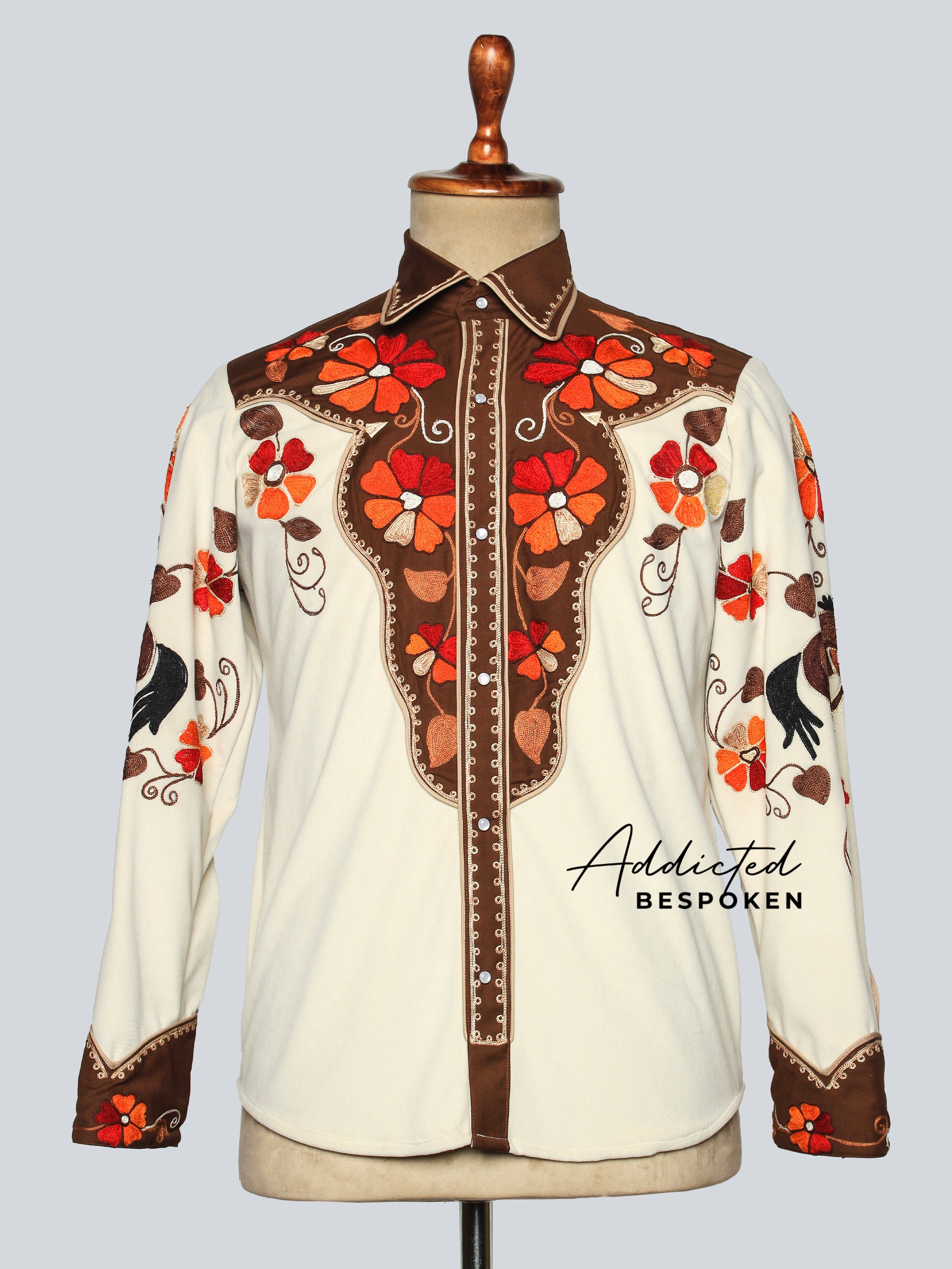 Front view of cream embroidered western shirt with red floral designs displayed on mannequin โ Addicted Bespoken