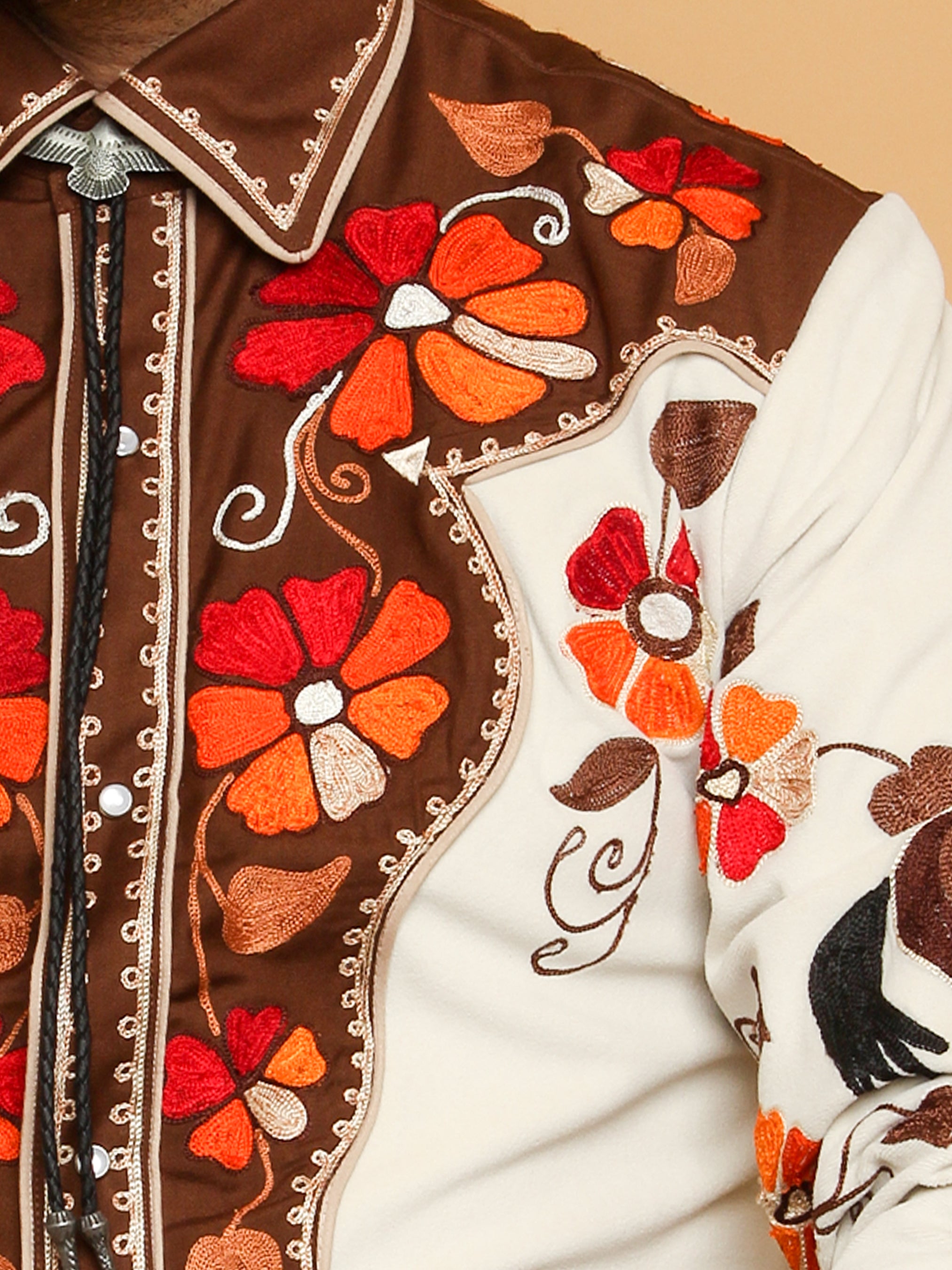 Close-up chest embroidery details of cream western shirt with red floral motifs โ Addicted Bespoken
