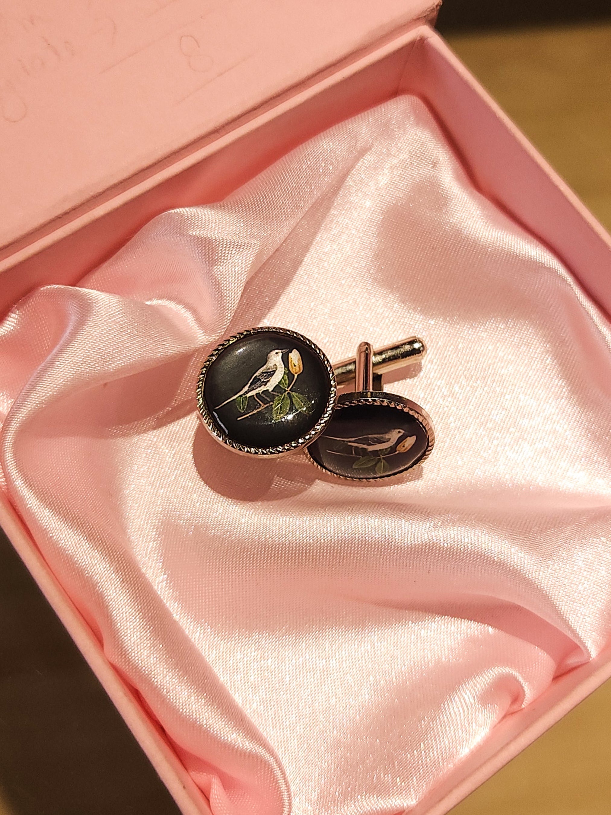 Pair of round enamel cufflinks with bird motif from Addicted Bespoken presented in a pink satin-lined gift box