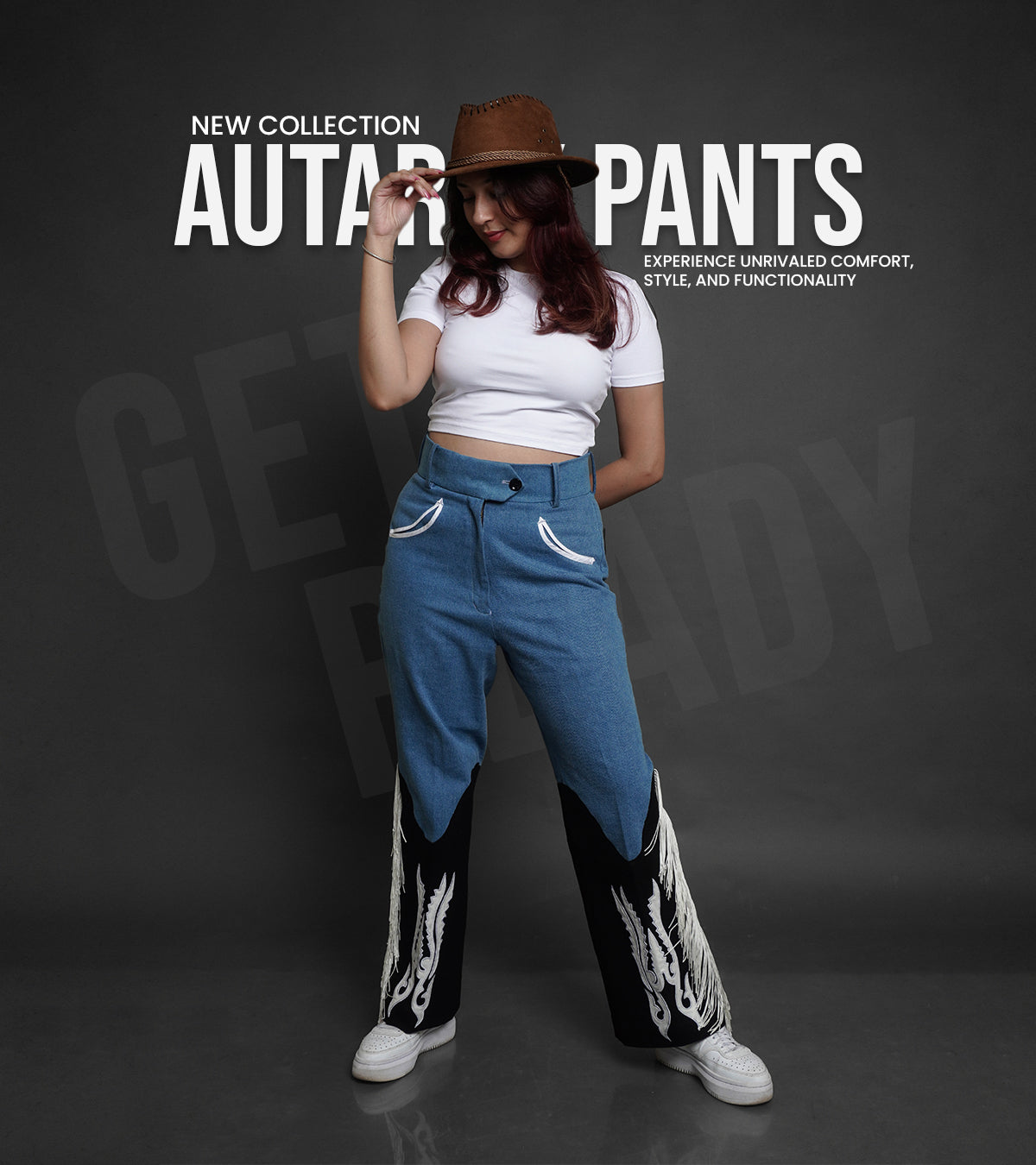 Model wearing Addicted Bespoken Autarky Pants from the new collection – high-waisted denim with black and white embroidery, styled with a white tee and hat.