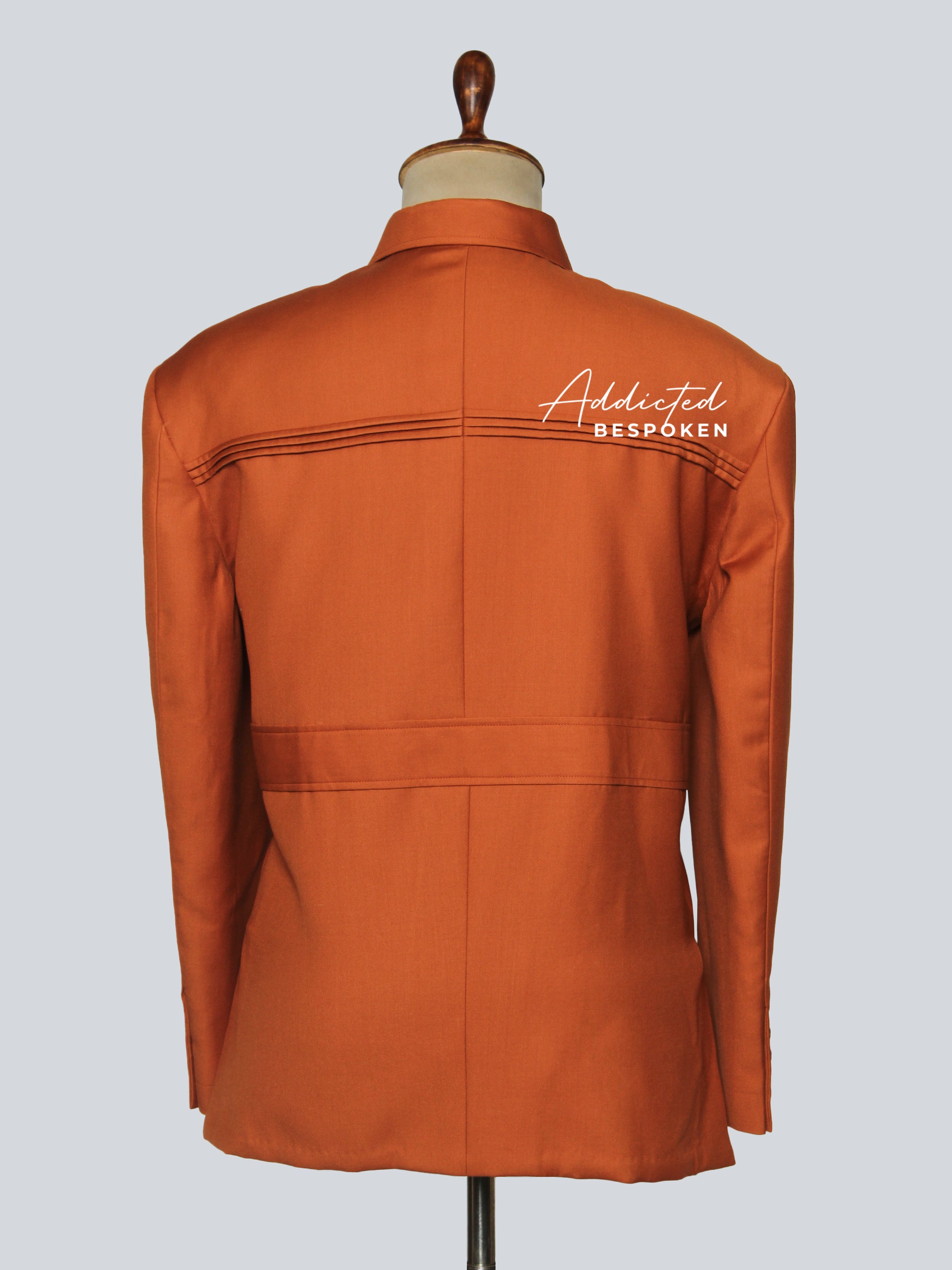 Back view of men’s signature safari suit – tailored rust brown jacket and trousers