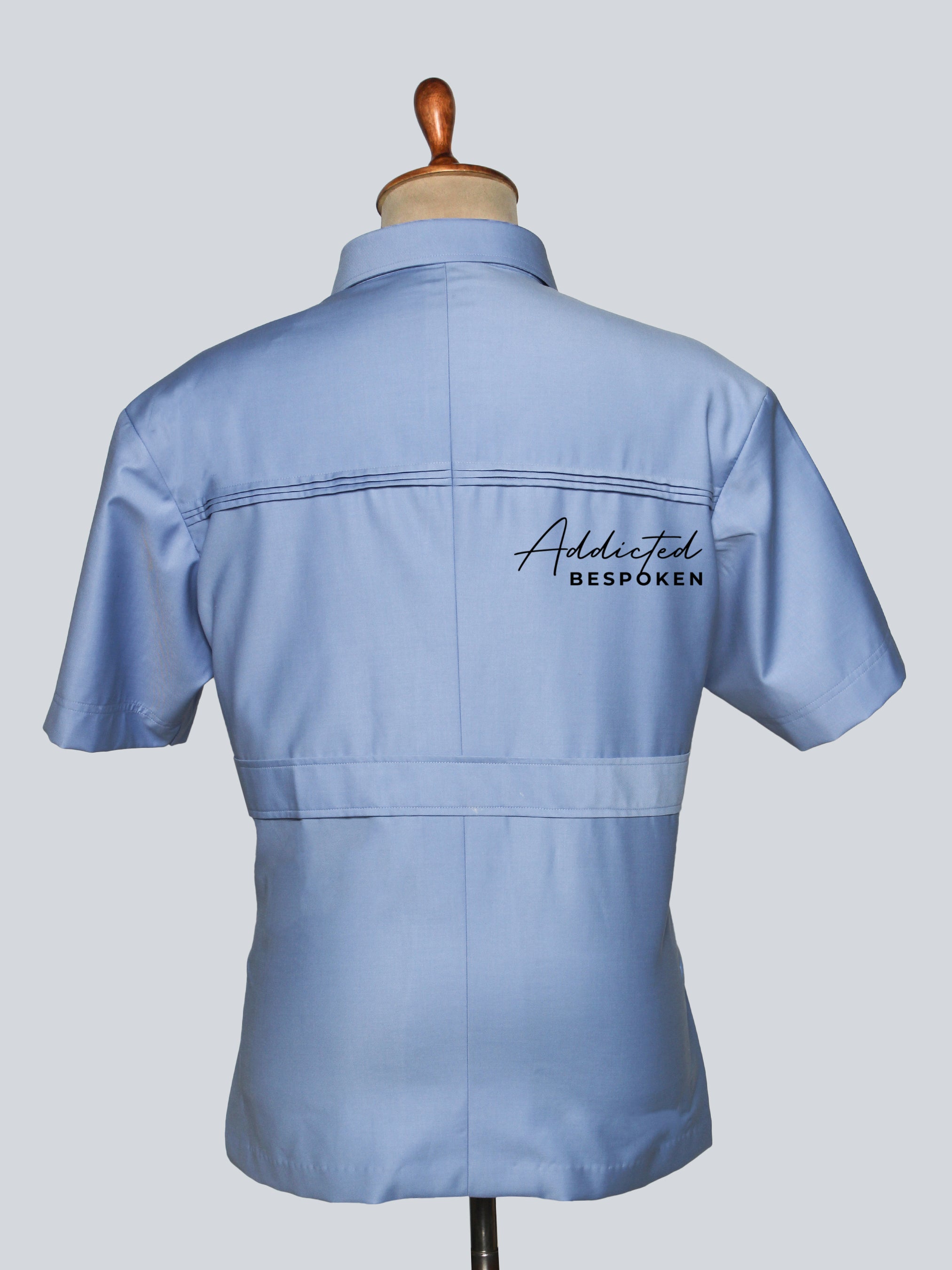 Back view of classic utility safari shirt – premium fabric with structured fit.