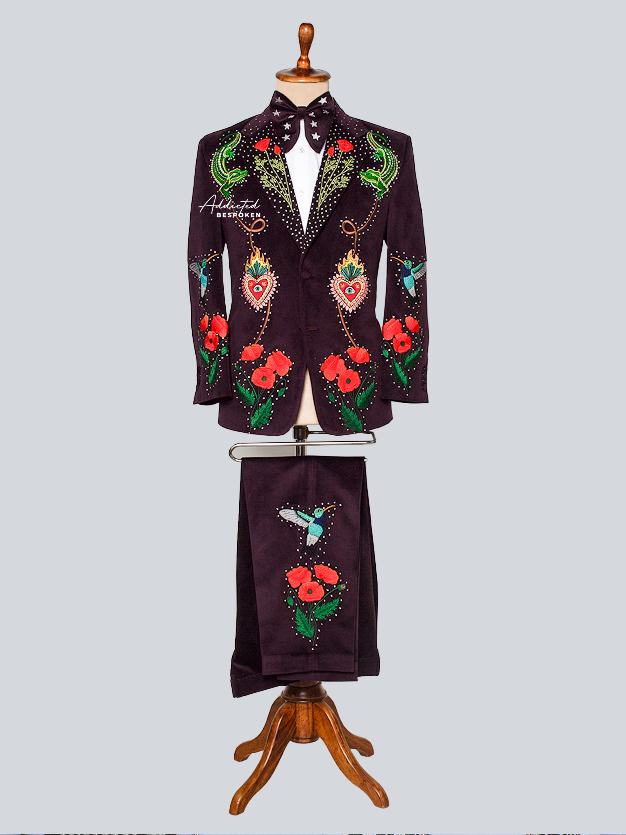 Embroidered blazer and pant set on a mannequin against a light gray background